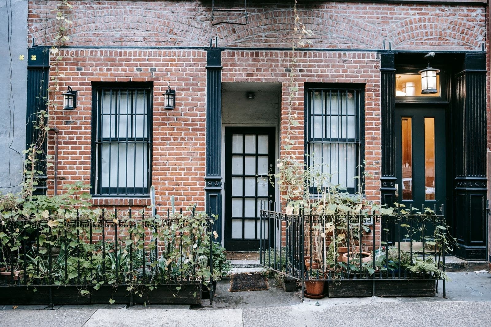 Brick townhouse with black window frames and a glazed front door